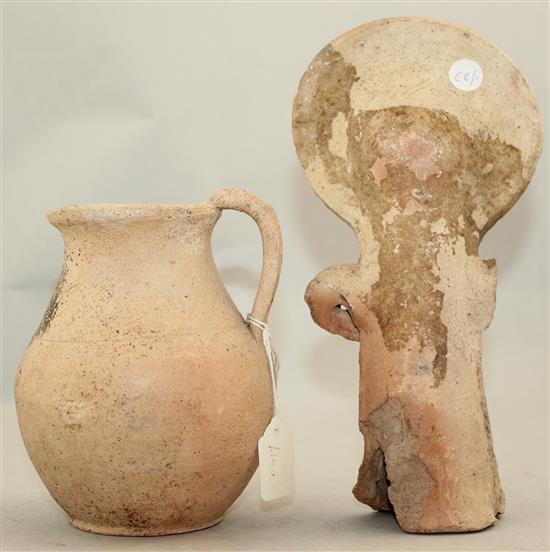 A Greek Cypriot terracotta figure of a goddess, 4th century BC and a Roman terracotta jug, c.2nd century AD, 20.5cm and 13cm
